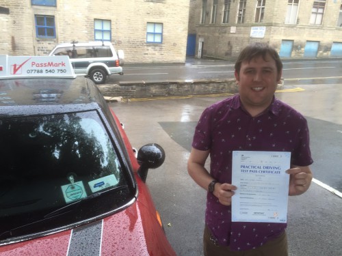 A photo of me posing with my Practical Driving Test Pass Certificate