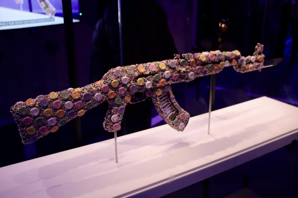 A disarmed AK-47 rifle that has been covered in sprinkles and Love Hearts sweets