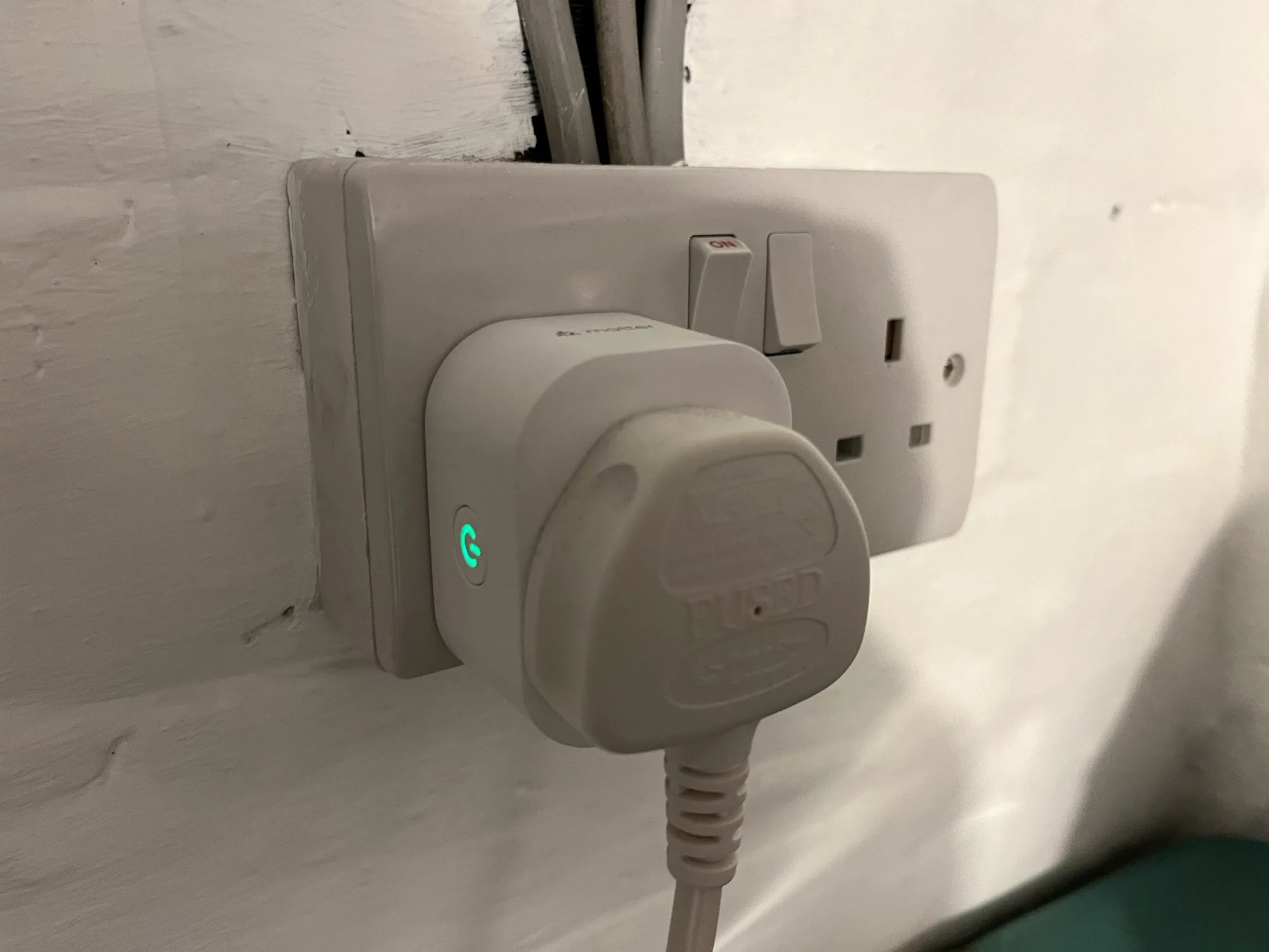 A photo of a Meross smart plug in a UK plug socket