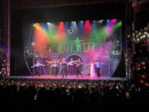 A photo of the encore of Unfortunate the Musical, showing a lit up stage at the Bradford Alhambra theatre