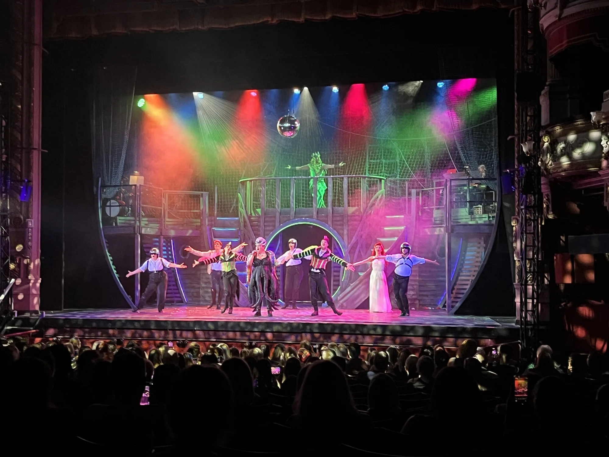 A photo of the encore of Unfortunate the Musical, showing a lit up stage at the Bradford Alhambra theatre