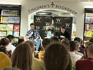Mark Cooper-Jones and Jay Foreman, aka the Map Men, in front of a crowd at Waterstones in Leeds