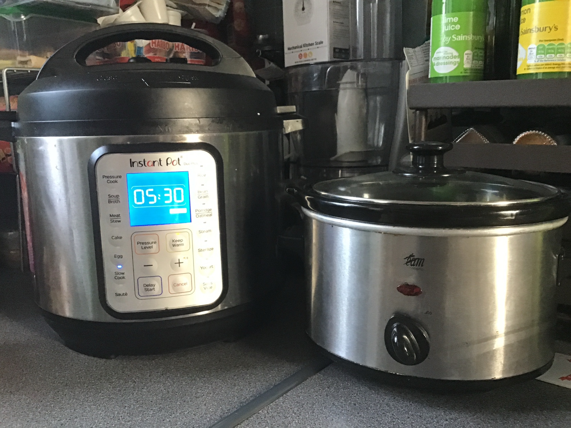 A photo of an Instant Pot next to a standard slow cooker