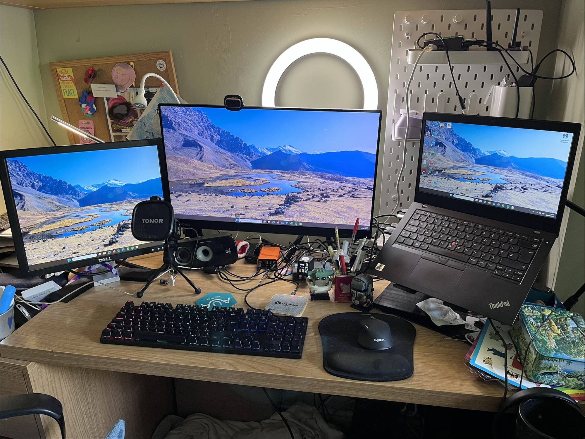My home working environment showing a laptop with Windows 11, and two external screens, for a total of three screens