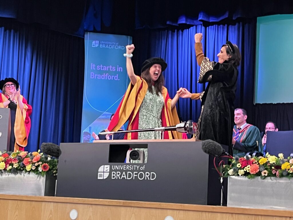 A photo of Rosie Jones receiving her honorary degree from Anita Rani at the University of Bradford.