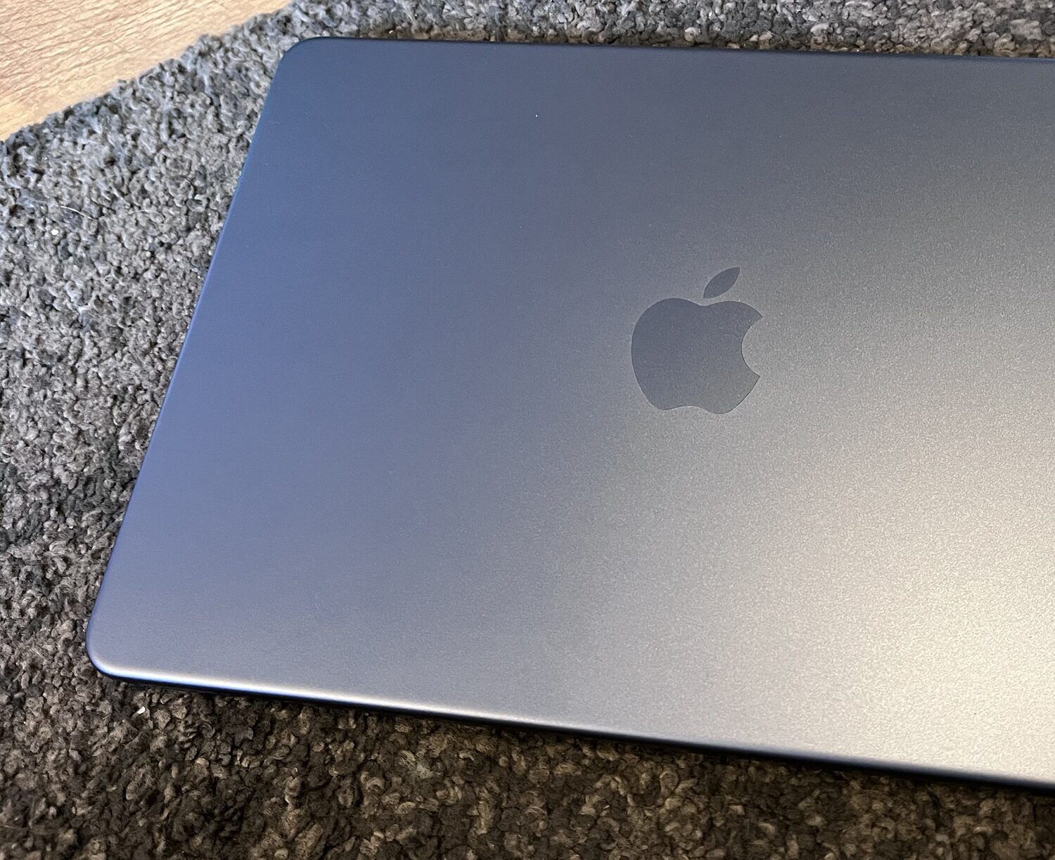 A photo of a blue Apple MacBook Neo with the lid closed