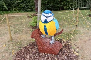 A photo of a blue tit made out of interlocking plastic bricks (Lego, basically) at the RHS Garden Harlow Carr