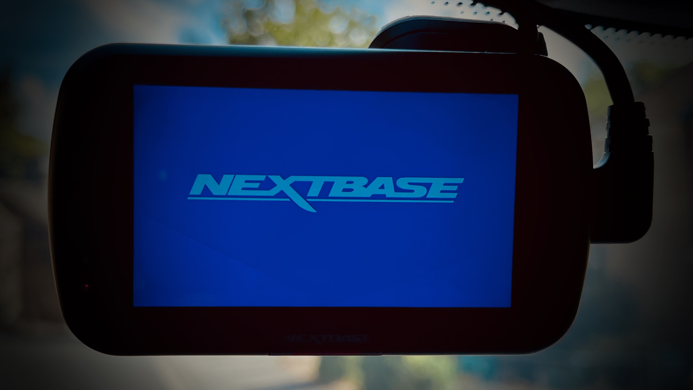 A photo of a front-facing Nextbase dashcam in our front windscreen