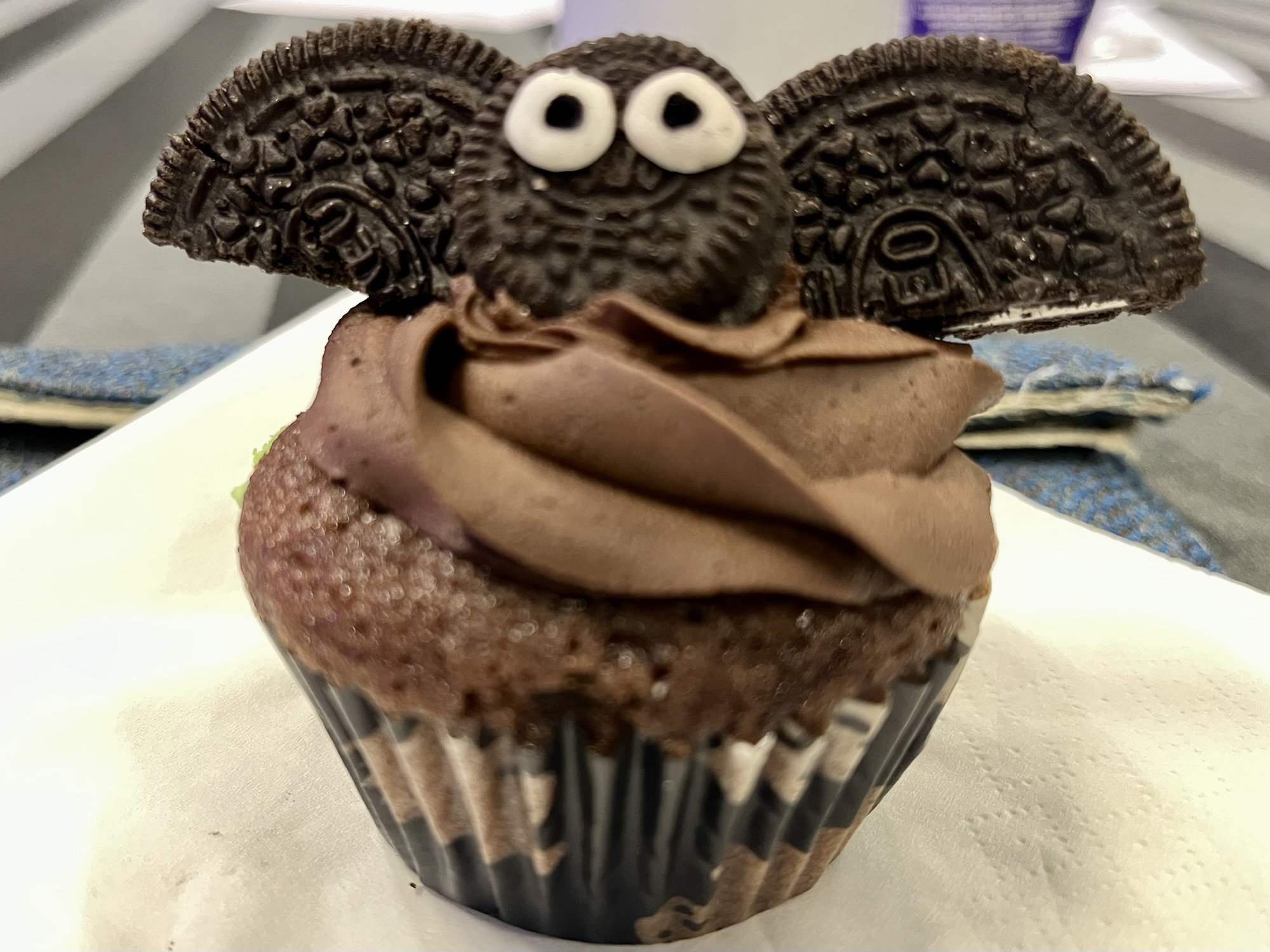 A cupcake with a bat on it, made out of Oreo cookies