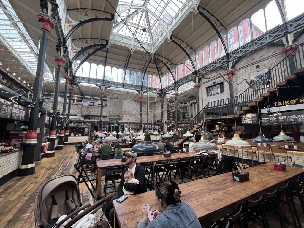A wide-angle photo taken inside Mackie Mayor showing its glass roof