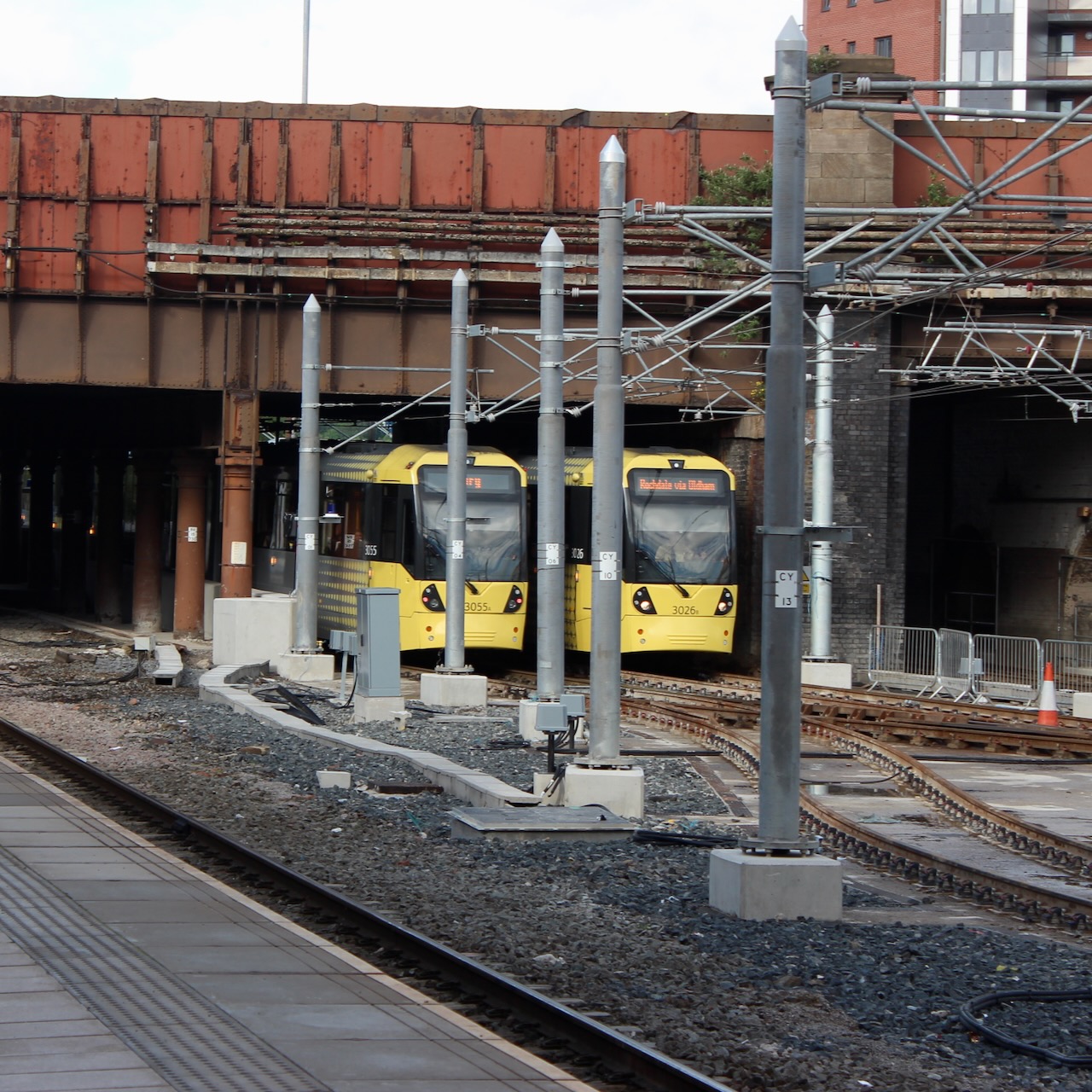 Two Metrolink trams approaching and leaving Manchester Victoria station